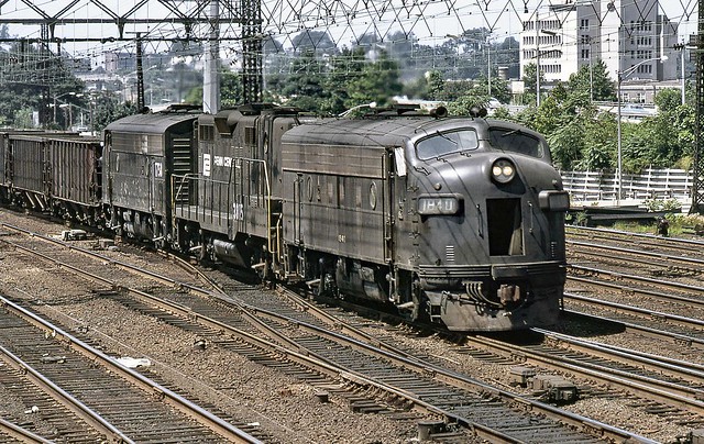 Penn Central EMD F7A # 1840, cabless GP9B # 3815 & F7A # 1758, as seen from tower SS38 by Bob Hughes with his camera, lead an eastbound manifest freight train under wire on a former New Haven Railroad express track through Stamford, CT, summer 1973