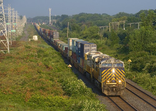 Ex-Citirail by Michael Berry Railfan, CN 108 has a pair of ex-Citirail units (CN 3915 & CN 3929) as it heads east into the sunrise jus