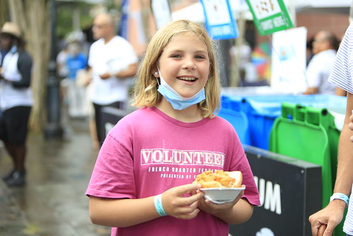 Volunteer with some yummy looking food at Satchmo SummerFest 2021. Photo by Michele Goldfarb.
