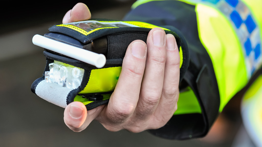 Breathaliser being offered by police officer.