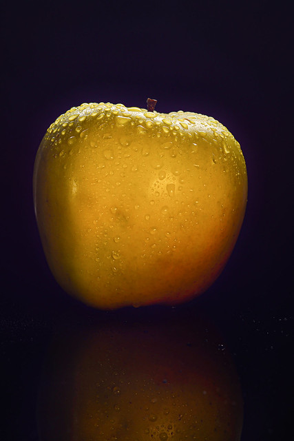 apple with water drops on black background
