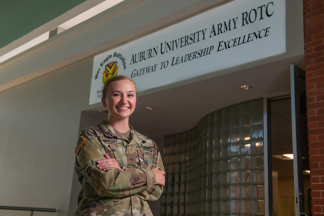 SeAnna Graddy in front of an Army ROTC sign