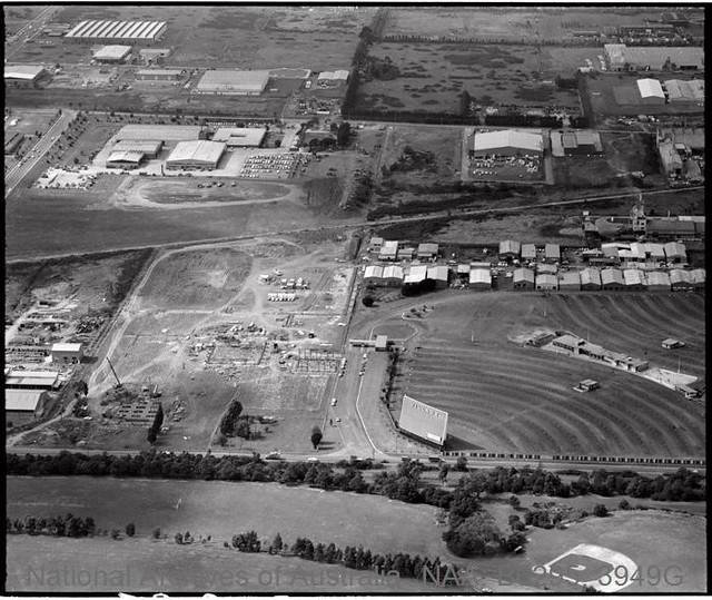 Aerial view looking east across Clayton Telecom Research Laboratories site under construction and Clayton Village drive-in, Blackburn Road,  1975