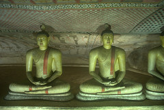 Sattues of Buddha with murals on the ceiling