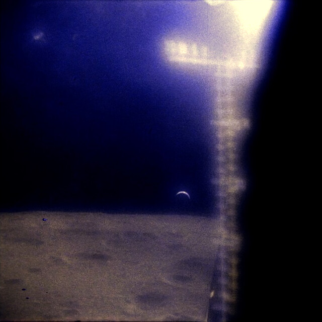 Apollo 12 view of a crescent Earth seen from the Lunar Module by Astronauts Pete Conrad and Alan Bean just after their ascent from the Moon
