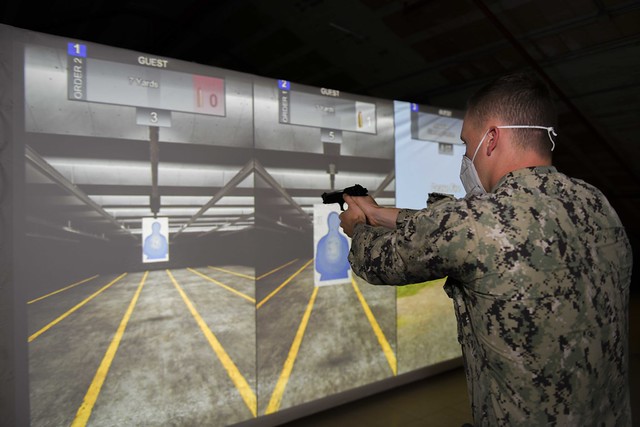 NSA Naples security personnel train in the firearms training simulator.