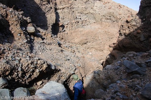 Scrambling back down a dryfall in Slot 3 of Sidewinder Canyon, Death Valley National Park, California