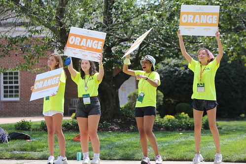 Exuberant orientation aides welcome new students and their families to campus.