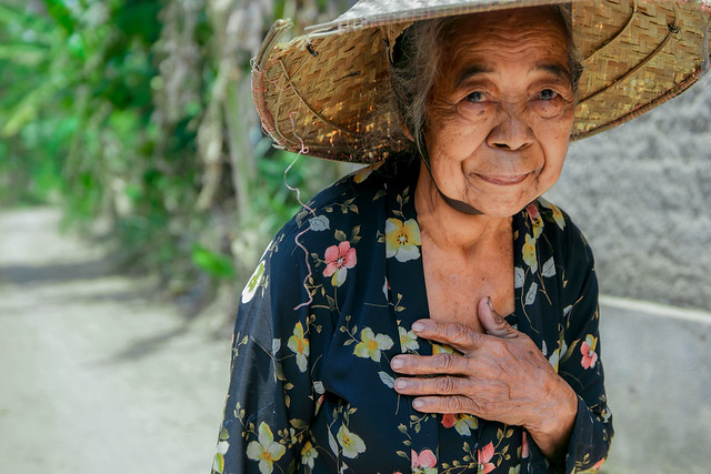 Beautiful elderly woman with straw hat in Indonesia