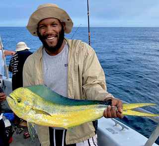 Photo of a man holding a dolphin fish