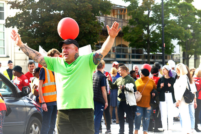 man with red balloon on his head