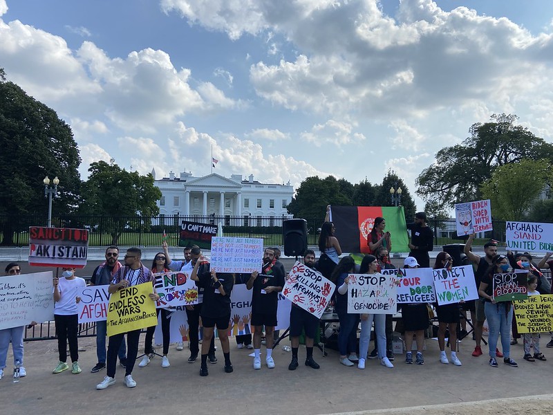 Protestors gather in front of the White House holding various signs