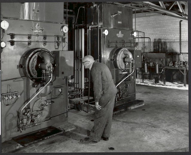 Elderly man looking at a steam generator, Pyrox factory, Clayton, 1956