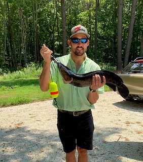 Photo of man holding a snakehead fish