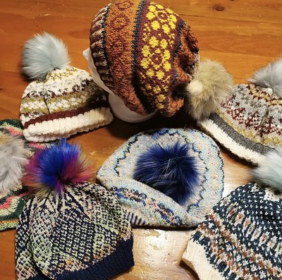 Paulette (@psknitting50) spent a few hours sewing pompoms onto all of these hats she knit this year!