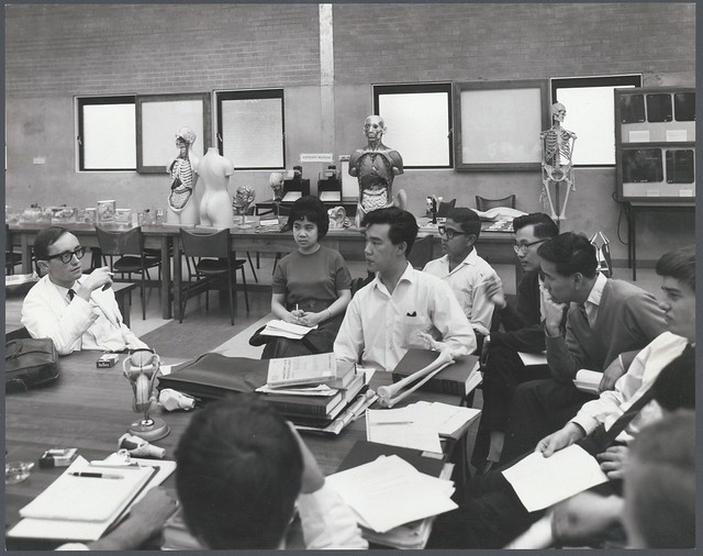 Medical students and teacher (smoking a cigarette) in classroom, Monash University, Clayton, 1963