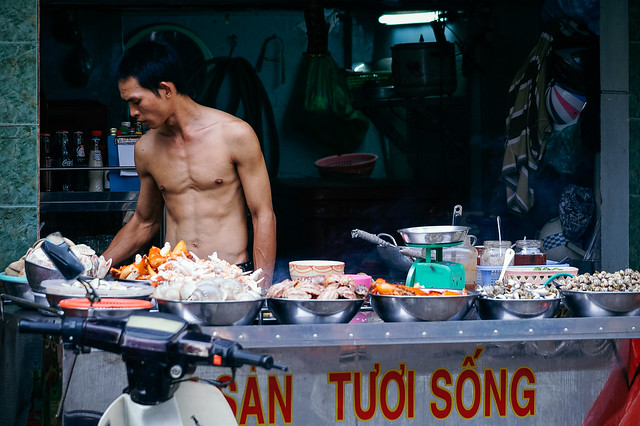 Topless cook at a street cockshop, Ho Chi Minh City (Vietnam)