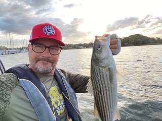 Photo of a man holding a striped bass