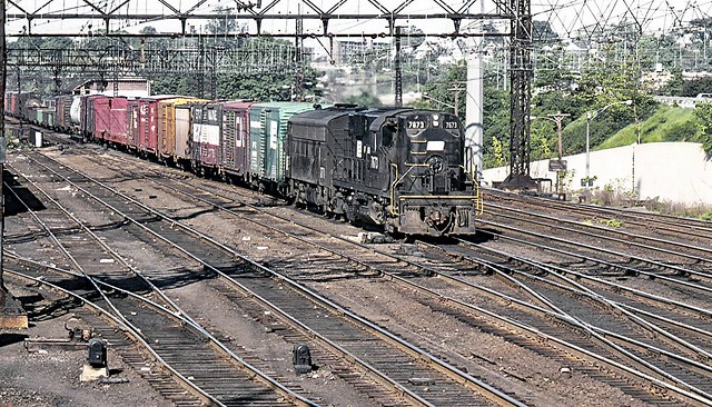 Penn Central ex New Haven Railroad ALCO RS-11 locomotive # 7673 and EMD F7A lead an eastbound manifest freight train on an express track near tower SS38 at Stamford, Connecticut, 1971