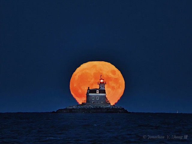 Harvest moon and lighthouse