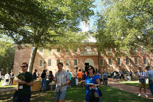 Families enjoy a picnic lunch in front of the Wren Building.