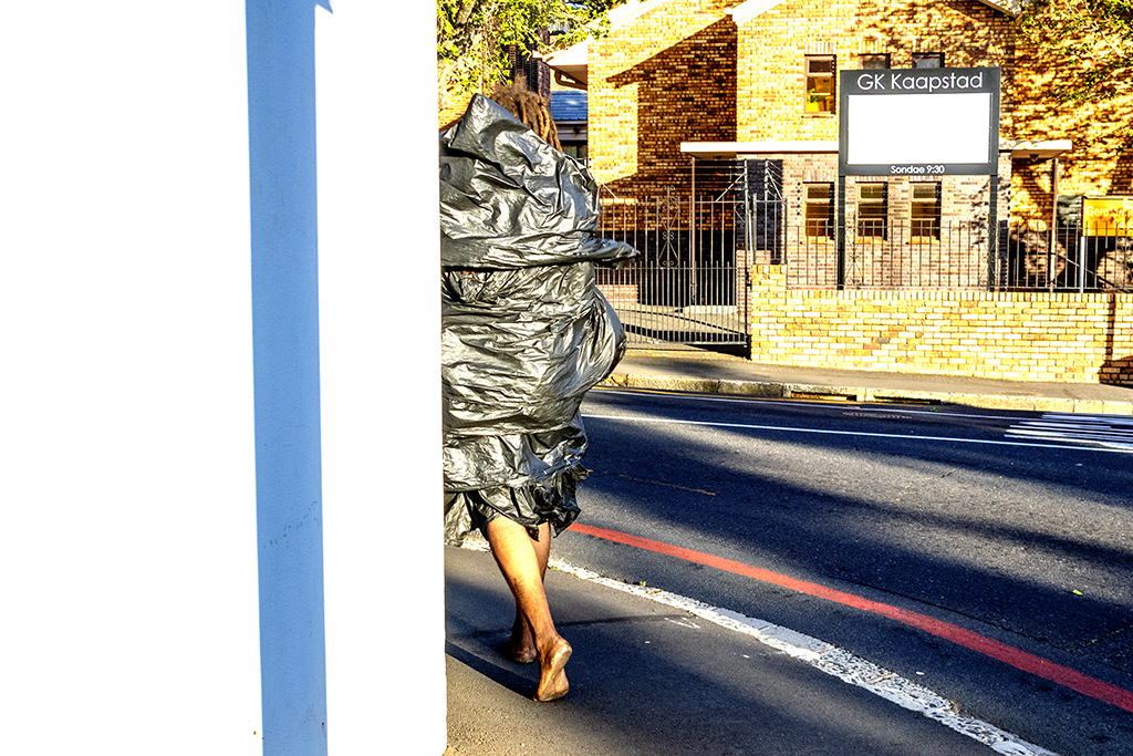 Homeless man wrapped in black plastic at Orange and Hof on 9-29-21--Cape Town