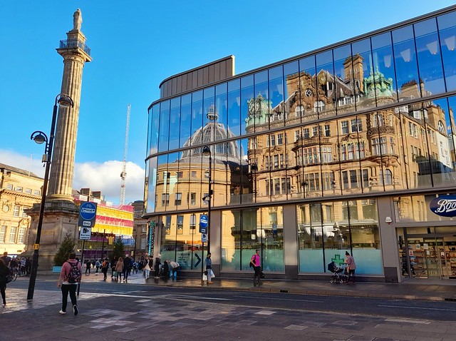 The Earl Grey monument and reflections of the Waterstone's Building upon Eldon Sq Shopping Centre.
