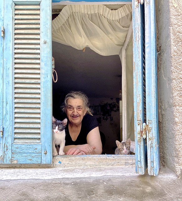 Chania, Crete. Woman and cats in Chania Old Town. Greece.