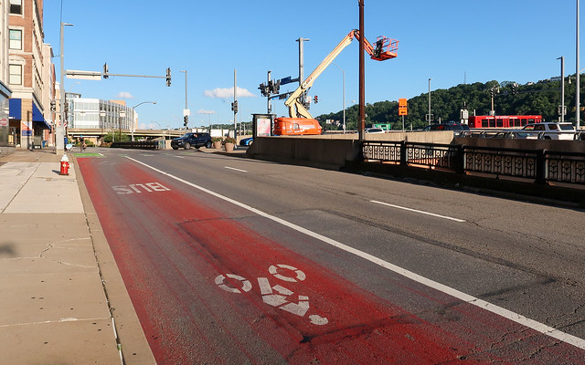 Disturbing representation of a bus dragging a bloodied and dying cyclist through the streets of downtown Pittsburgh.