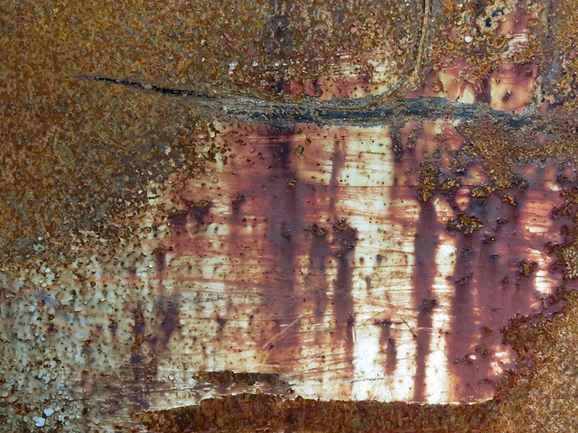 abstract texture of scraped rust on a dumpster