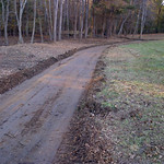 Grading for a residential asphalt driveway.  Grading and compacting the subgrade for a new residential asphalt driveway.