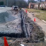 French Drain Installation. Installing a french drain in a parking lot can help with excessive ground water.