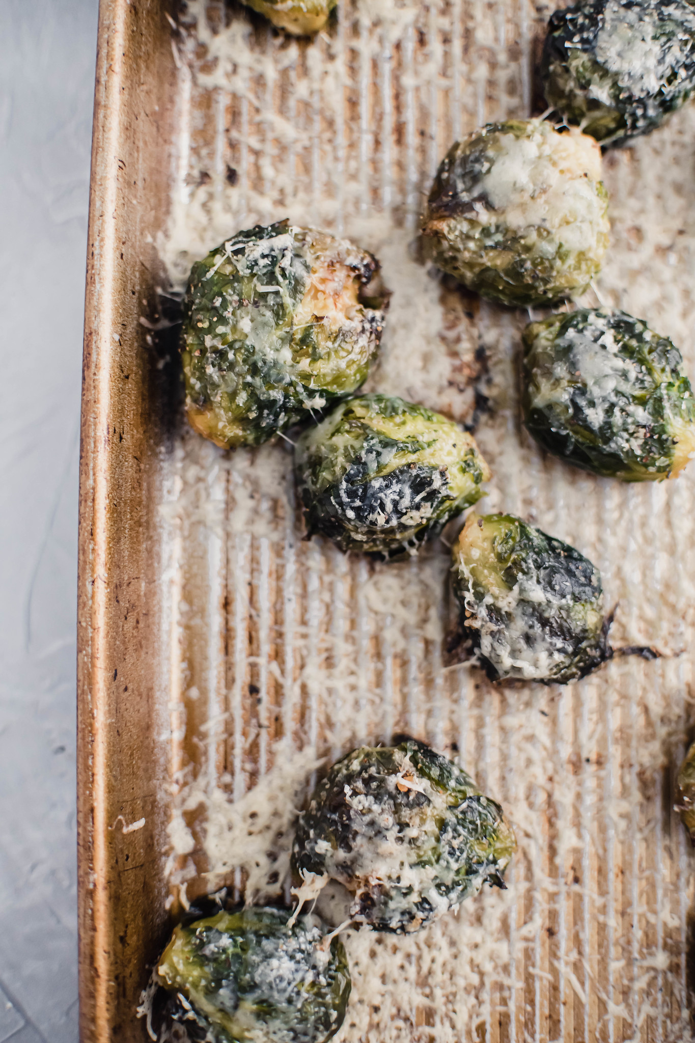 Crispy roasted parmesan brussels sprouts on a baking sheet.