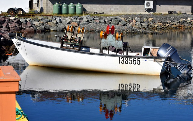 A WORKBOAT,  BIG WINCHES FOR FISHING.  REFLECTIONS IN A SAFE HARBOR.    NEWFOUNDLAND.