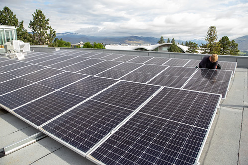 Solar panels being installed on roof of Chappell Family Building for Nursing and Population Health