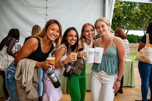 Friends gather for their Cheers to Your Senior Year party in the Sunken Garden tent.