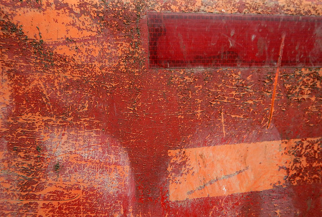 Abstract red on a dumpster
