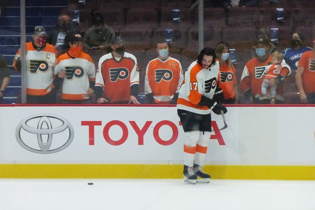 Masked up Flyers fans on the glass and Zack MacEwen