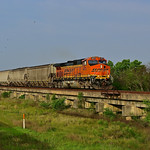4/26/21, BNSF C44-9W 4673 Heading north on the KCS over Copano Creek with enpty grain hoppers.