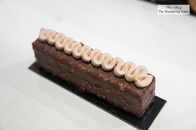Noisette - Almond biscuit covered with delicious hazelnut cream, coated with a fine crispy layer of milk and almond chocolate and decorated with ganache flavoured with hazelnut and milk gianduja cocoa