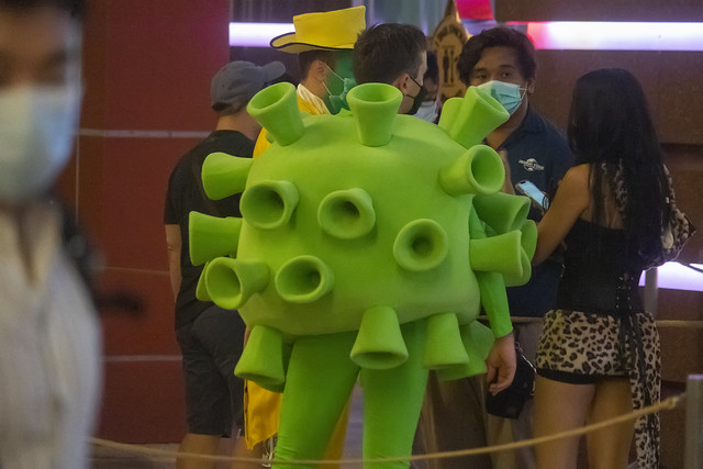 Man in coronavirus costume has trouble entering theme park