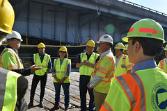 State Rep Cindy Harrison and other officials listen during a DOT  tour of construction of the Rochambeau Bridge.
