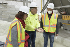 State Rep. Cindy Harrison, and Southbury resident Tom Connor look on as Urban Mining's Patrick Grasso shows off “Pozzotive,” an environmentally friendly component used to make concrete.