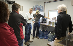 State Rep. Cindy Harrison, and Southbury residents Tom Connor and Ken and Barbara Donahue, listen as Urban Mining's Patrick Grasso explains the process that turns used glass bottles into “Pozzotive,” an environmentally friendly component used to make concrete.