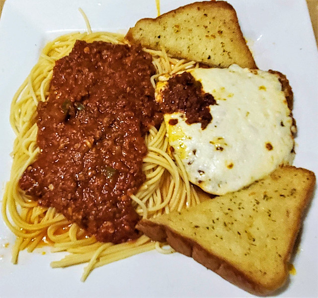 Veal parmigiana cutlet; spaghetti with meat sauce; garlic bread