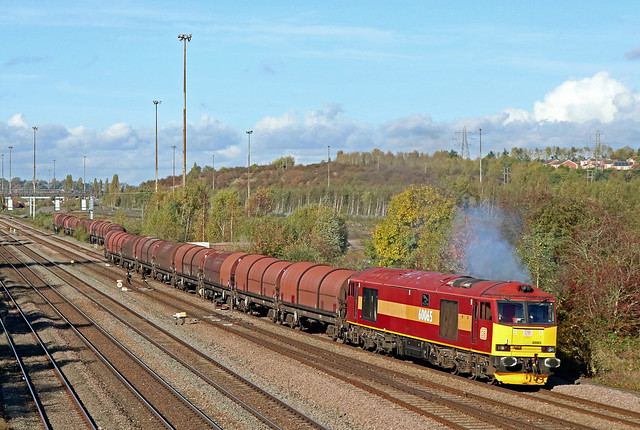 A rare outing for DB Cargo Class 60 No 60065 'Spirit of Jaguar' seen clagging smoke leaving Toton on 2.11.21 with 6E02 1220 Toton Up Sidings to Boston Sleaford Sidings empty steel carriers