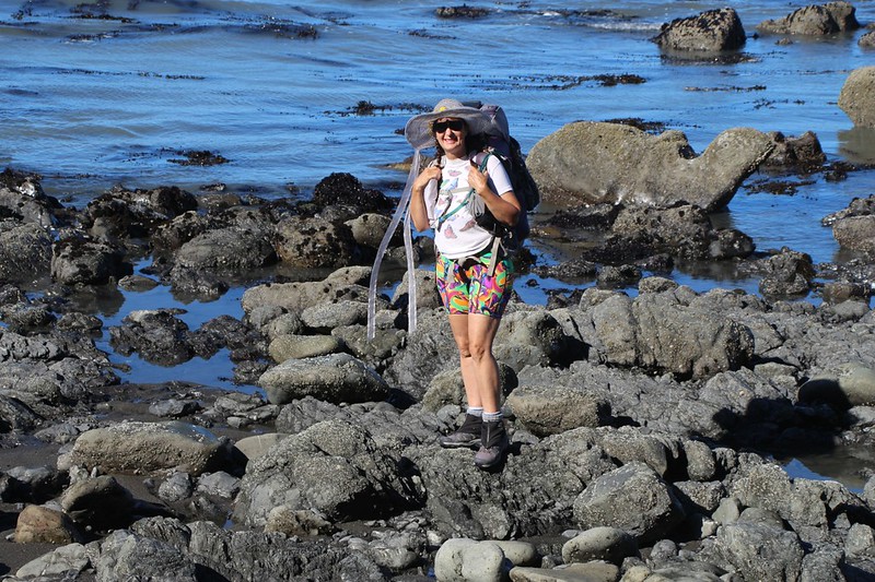 Happy Vicki checking out the sea life in the tidepools along the rocky beach at low tide, on the Lost Coast Trail
