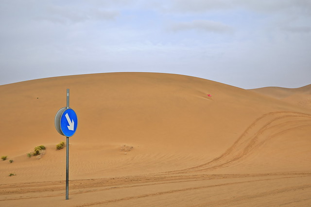 Road sign among sand dunes-Badain Jaran section of Gobi Desert. Inner Mongolia-China-1026