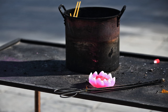 Pink lotus flower wax candle-rusty iron stock pot. Dafo Si-Zhangye-China-1284
