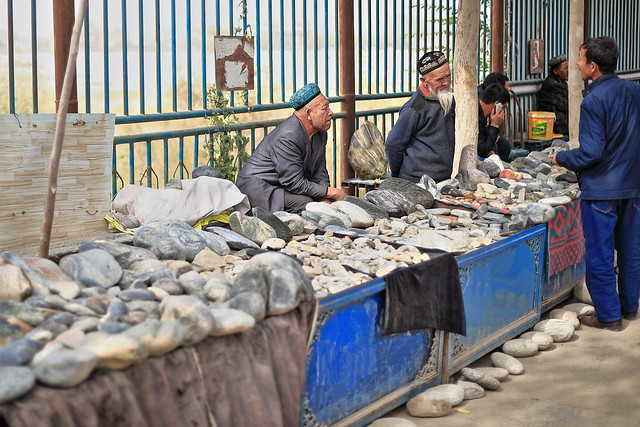 Uyghur mineral vendors at their market stall bargaining with customers. Jade Bazaar-Hotan-Xinjiang-China-0154